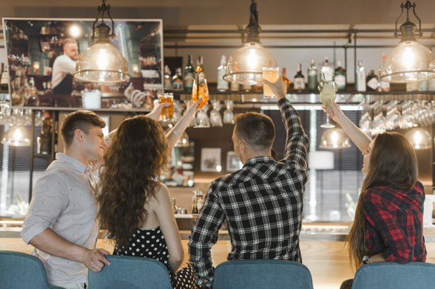 group-friends-enjoying-drinks-bar_23-2147859498